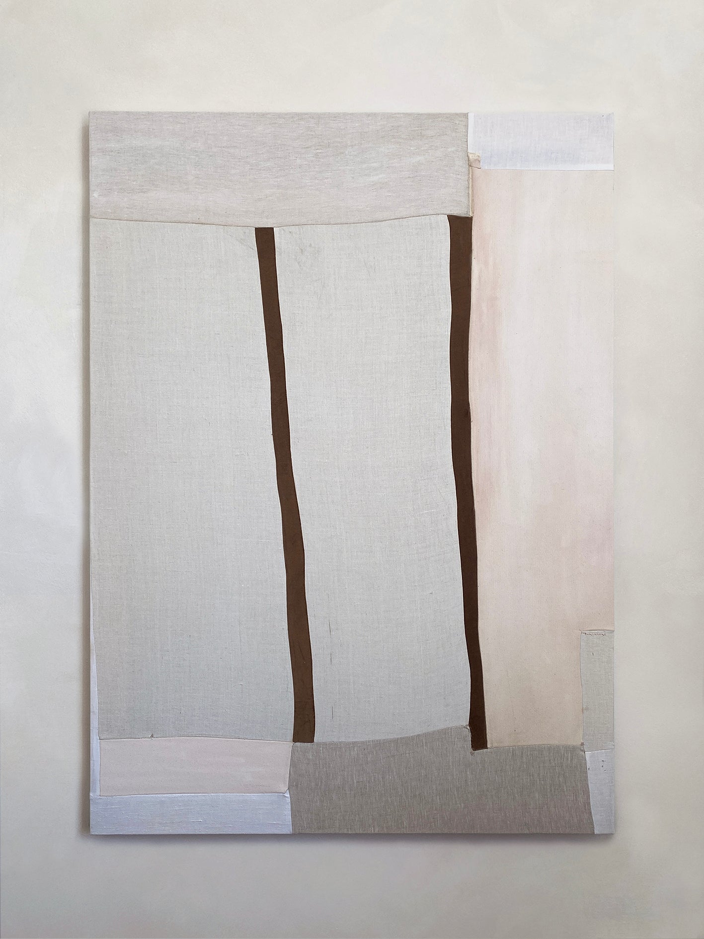 a large abstract artwork with neutral fabric painterly elements and two strips of brown velvet