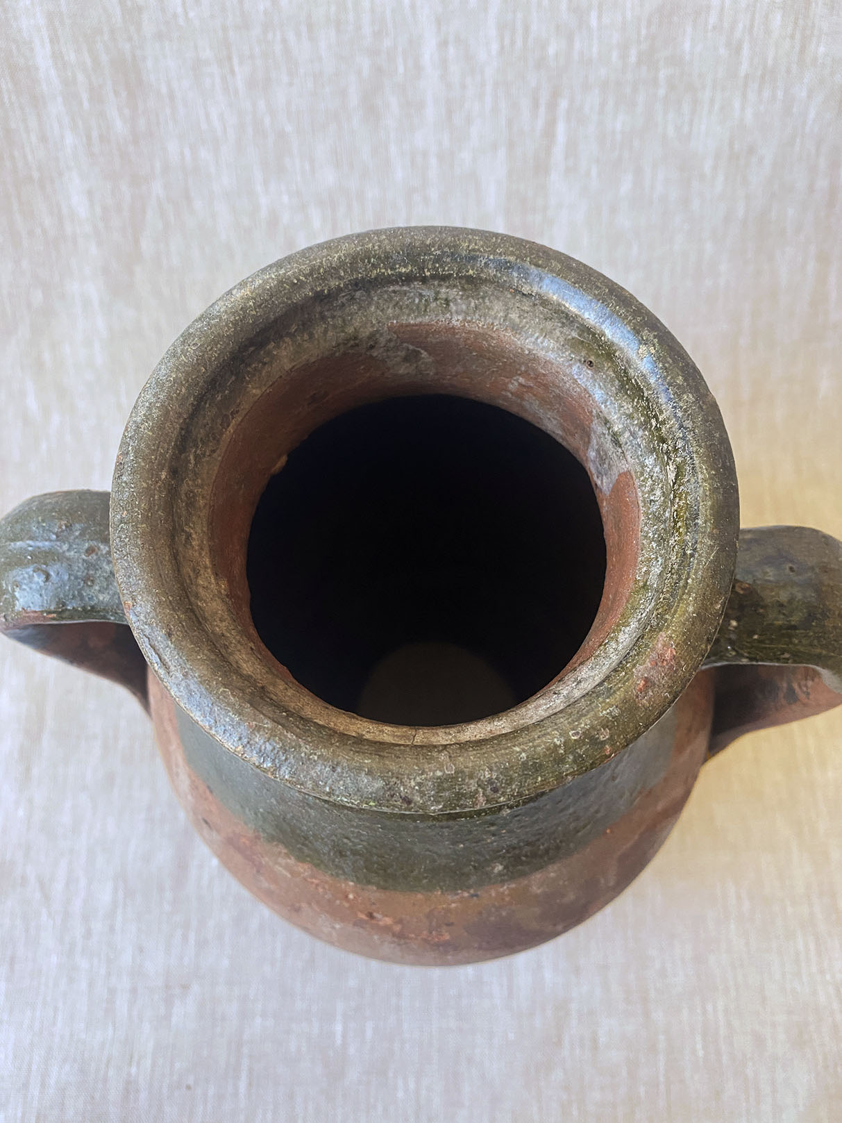 a rustic double-handle turkish drip vase traditionally used to store oil in the off season