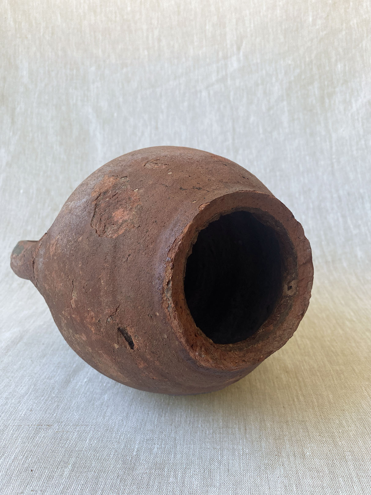 a rustic double-handle turkish drip vase traditionally used to store oil in the off season