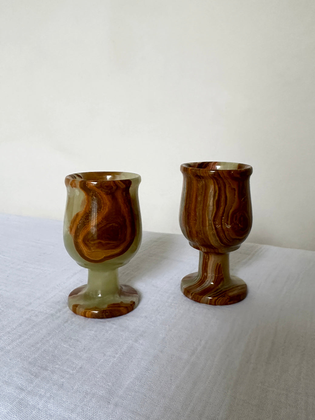 a pair of vintage onyx egg cups, originally designed as shot glasses