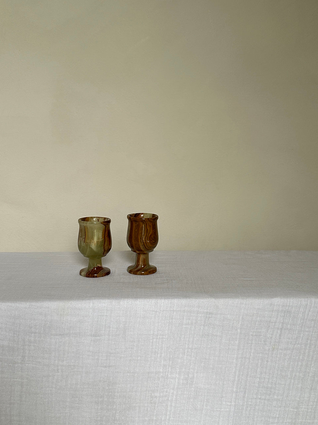 a pair of vintage onyx egg cups, originally designed as shot glasses