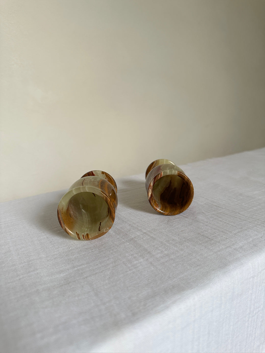 a pair of vintage onyx egg cups, originally designed as shot glasses