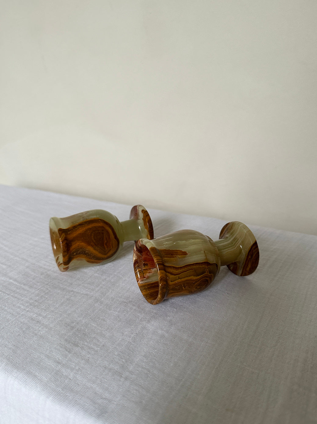 a pair of vintage onyx egg cups, originally designed as shot glasses