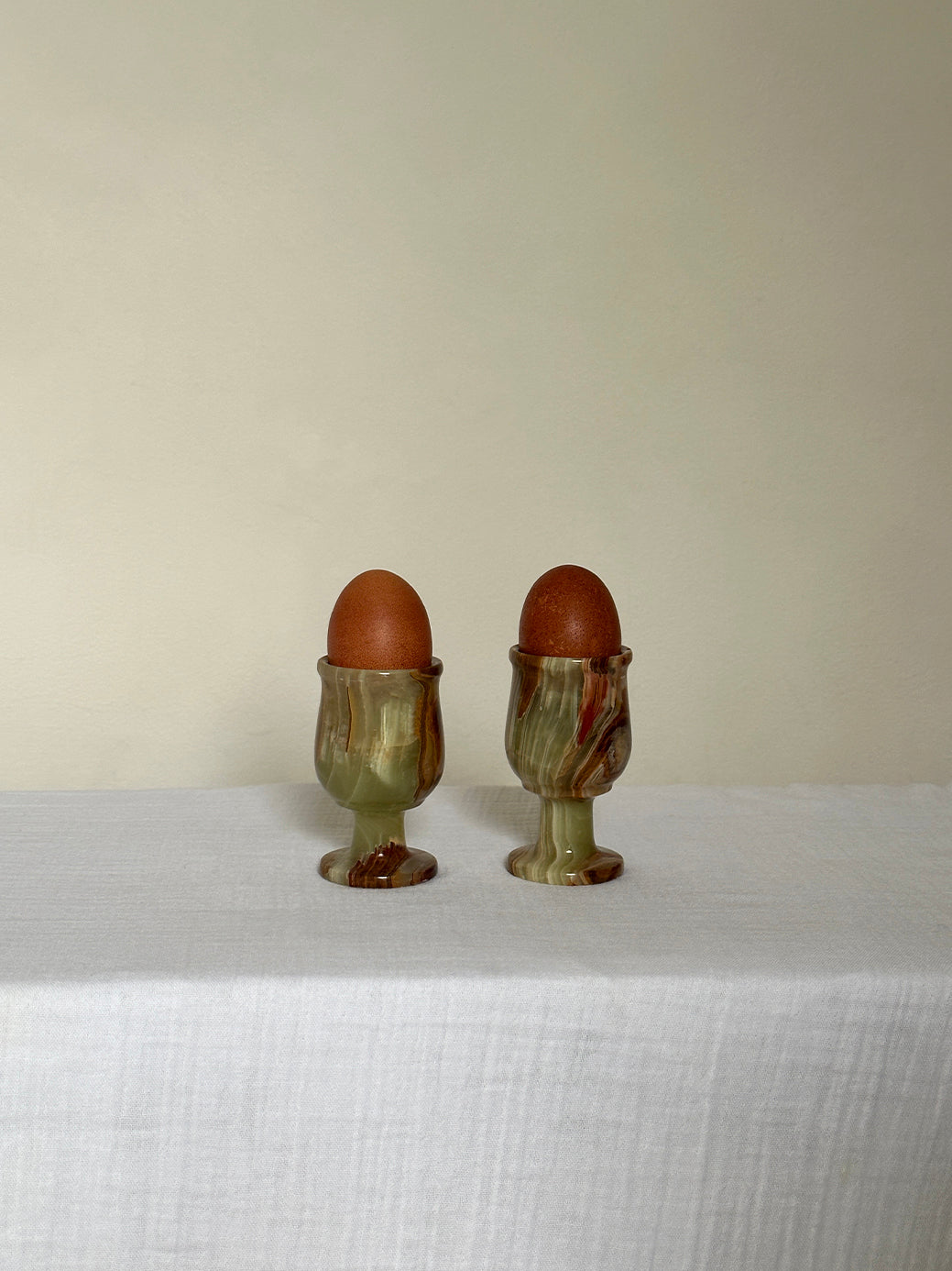 a pair of vintage onyx egg cups, originally designed as shot glasses