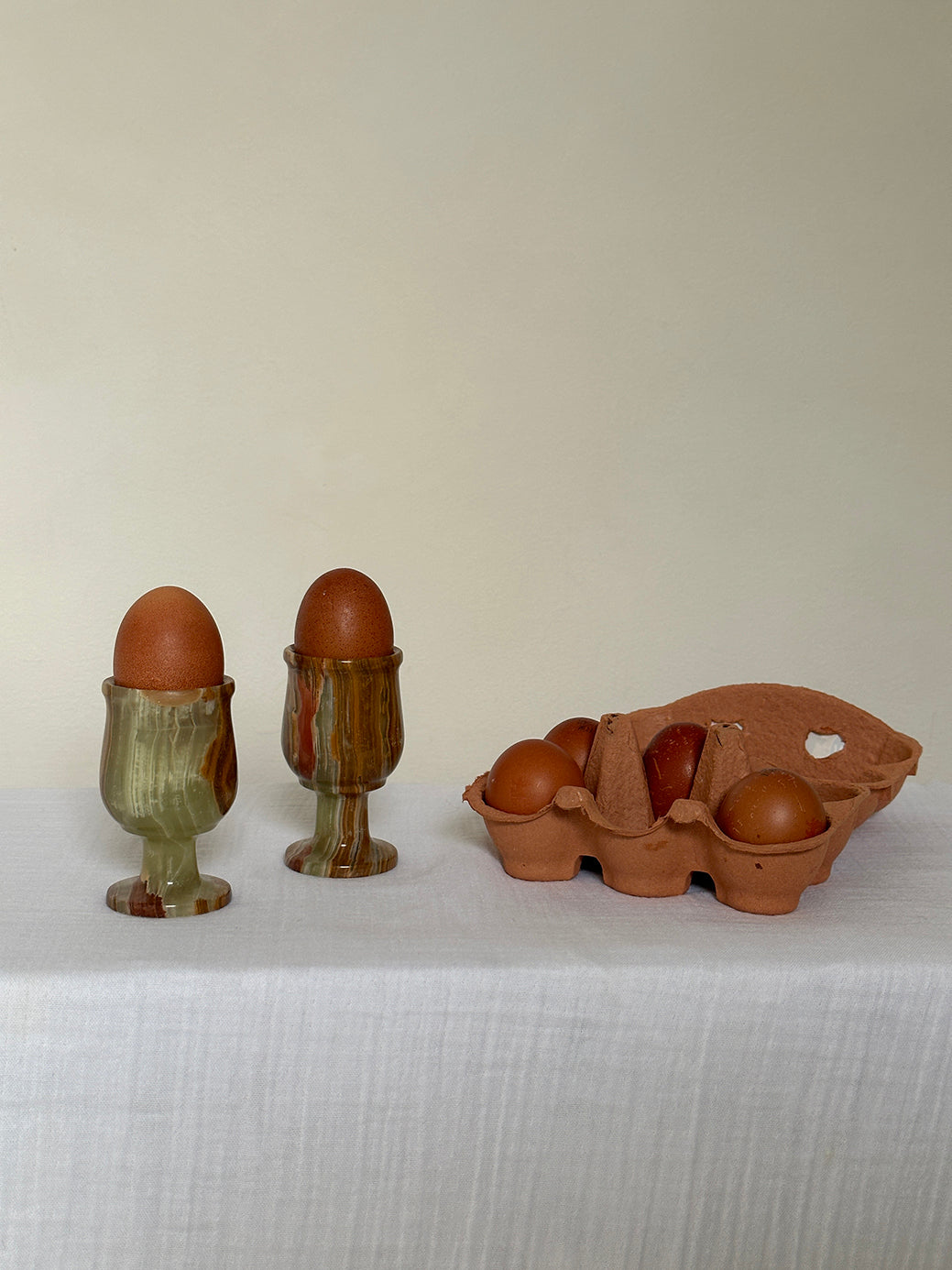 a pair of vintage onyx egg cups, originally designed as shot glasses