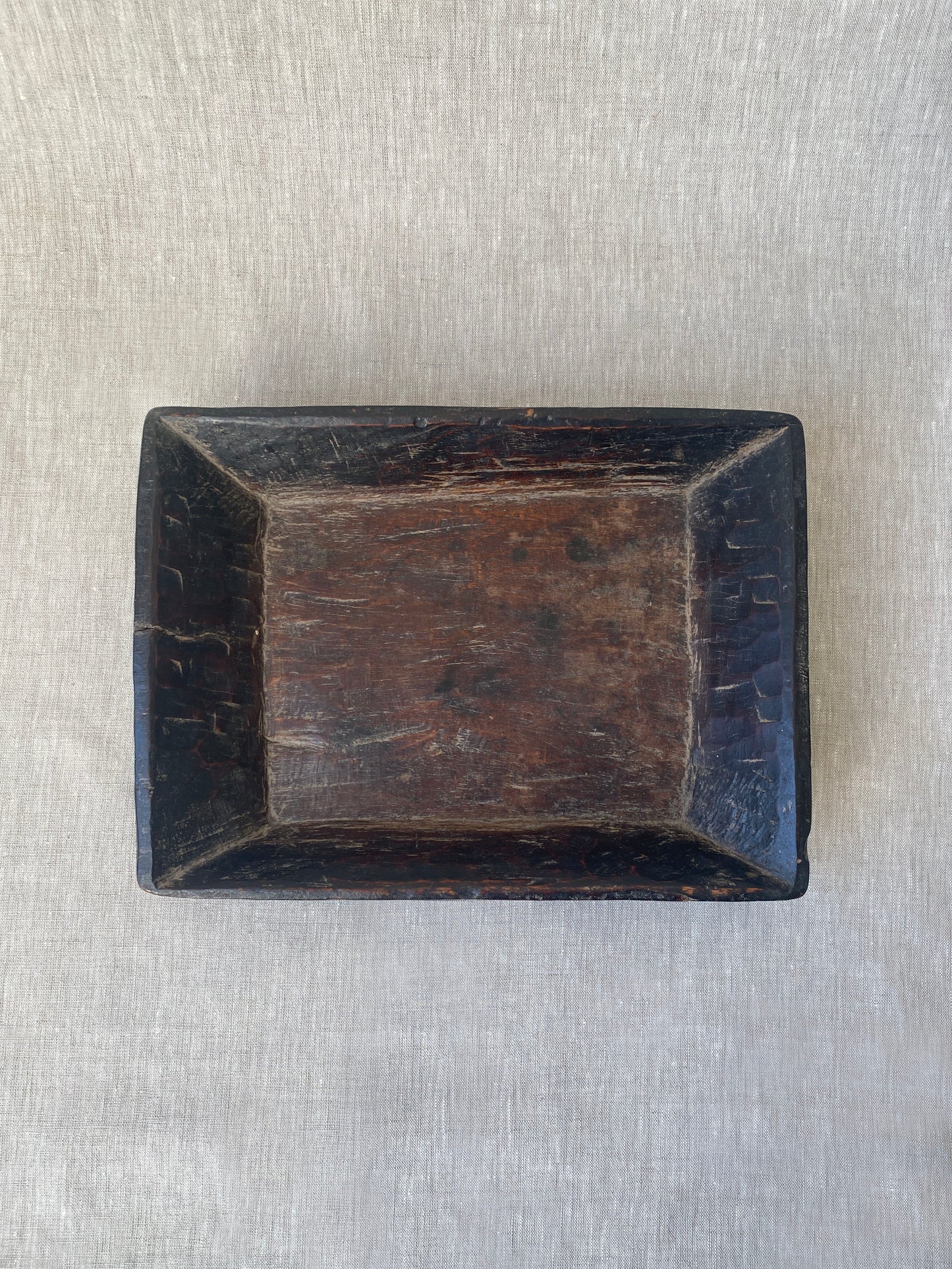 an antique hand carved wooden dish