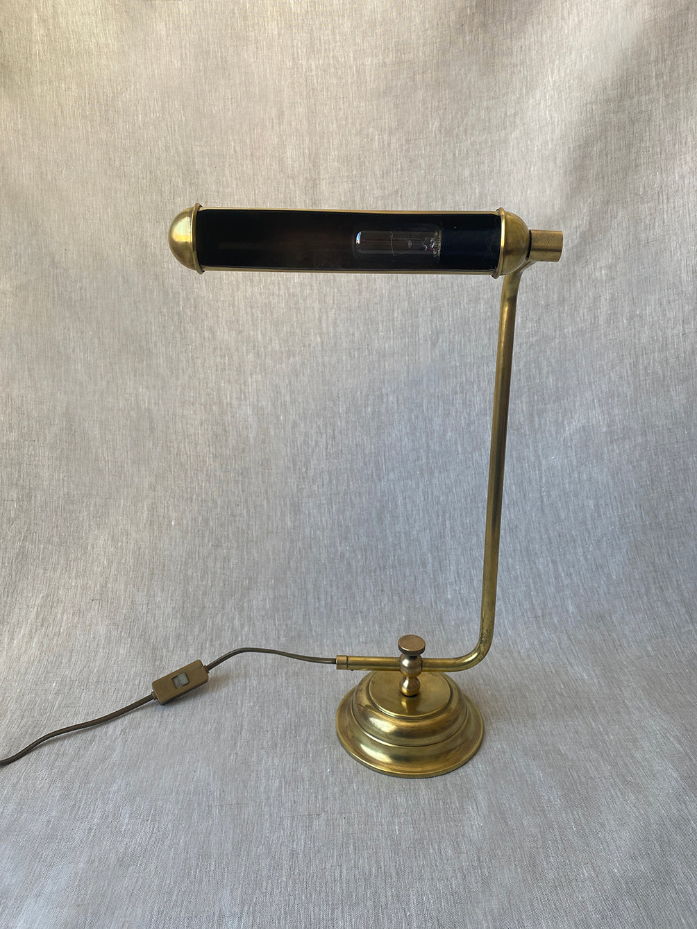 a mid-century solid brass table lamp with adjustable shade and stem
