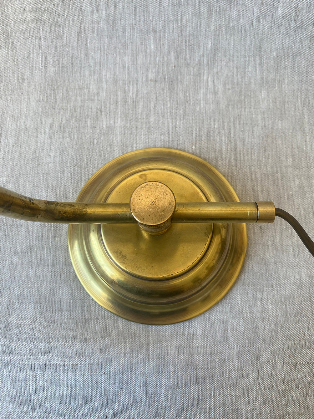 a mid-century solid brass table lamp with adjustable shade and stem