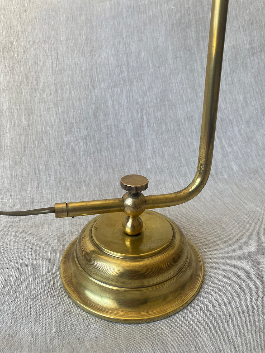 a mid-century solid brass table lamp with adjustable shade and stem