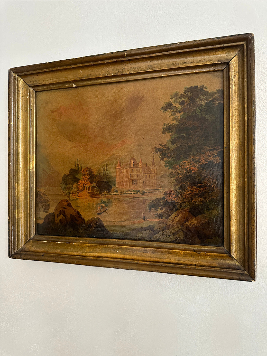 an antique oil painting in a gilt wood frame, of a french chateau and landscape 