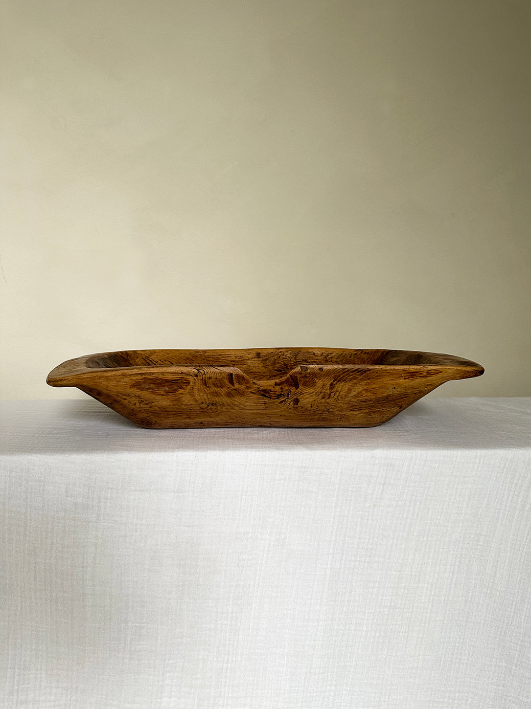 a primitive antique dough trough in handcarved wood