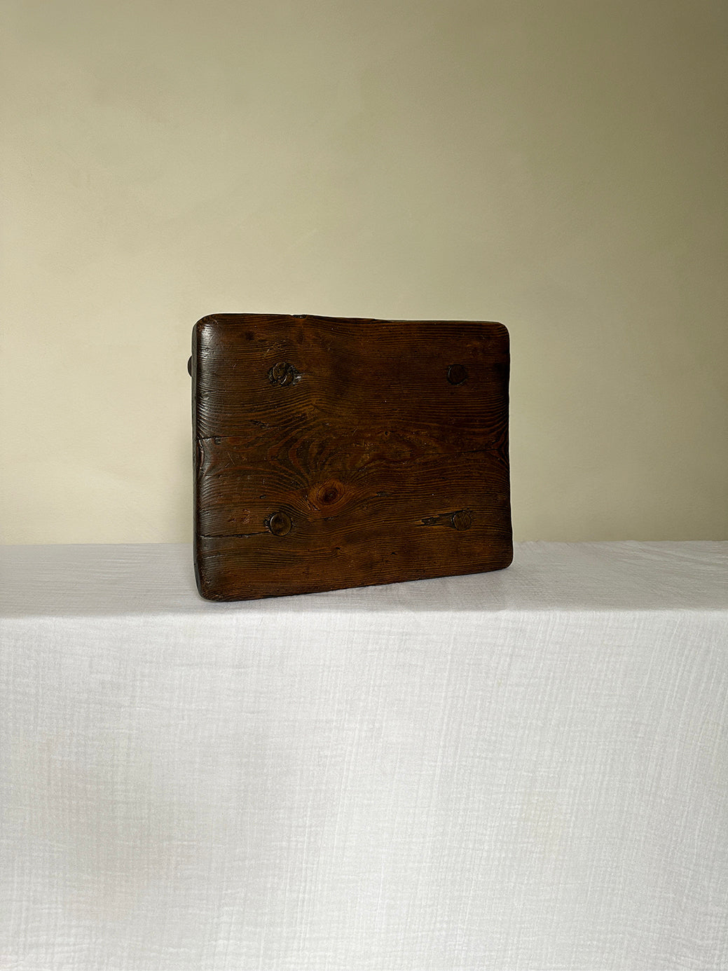 an antique wabi sabi table stool hand-carved from super sturdy dark wood