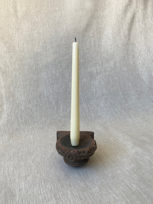 a rustic, hand-carved wooden candle sconce with delicate engraving 