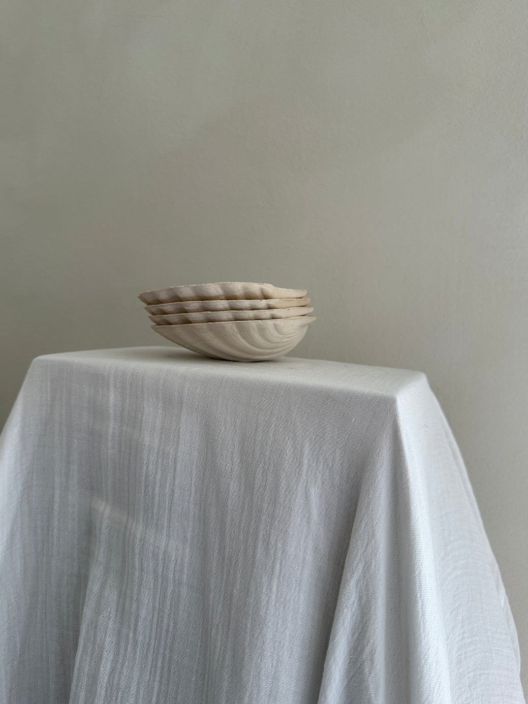 a set of four vintage french scallop serving dishes in natural, unglazed clay