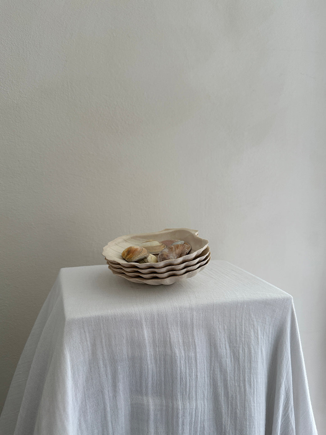 a set of four vintage french scallop serving dishes in natural, unglazed clay