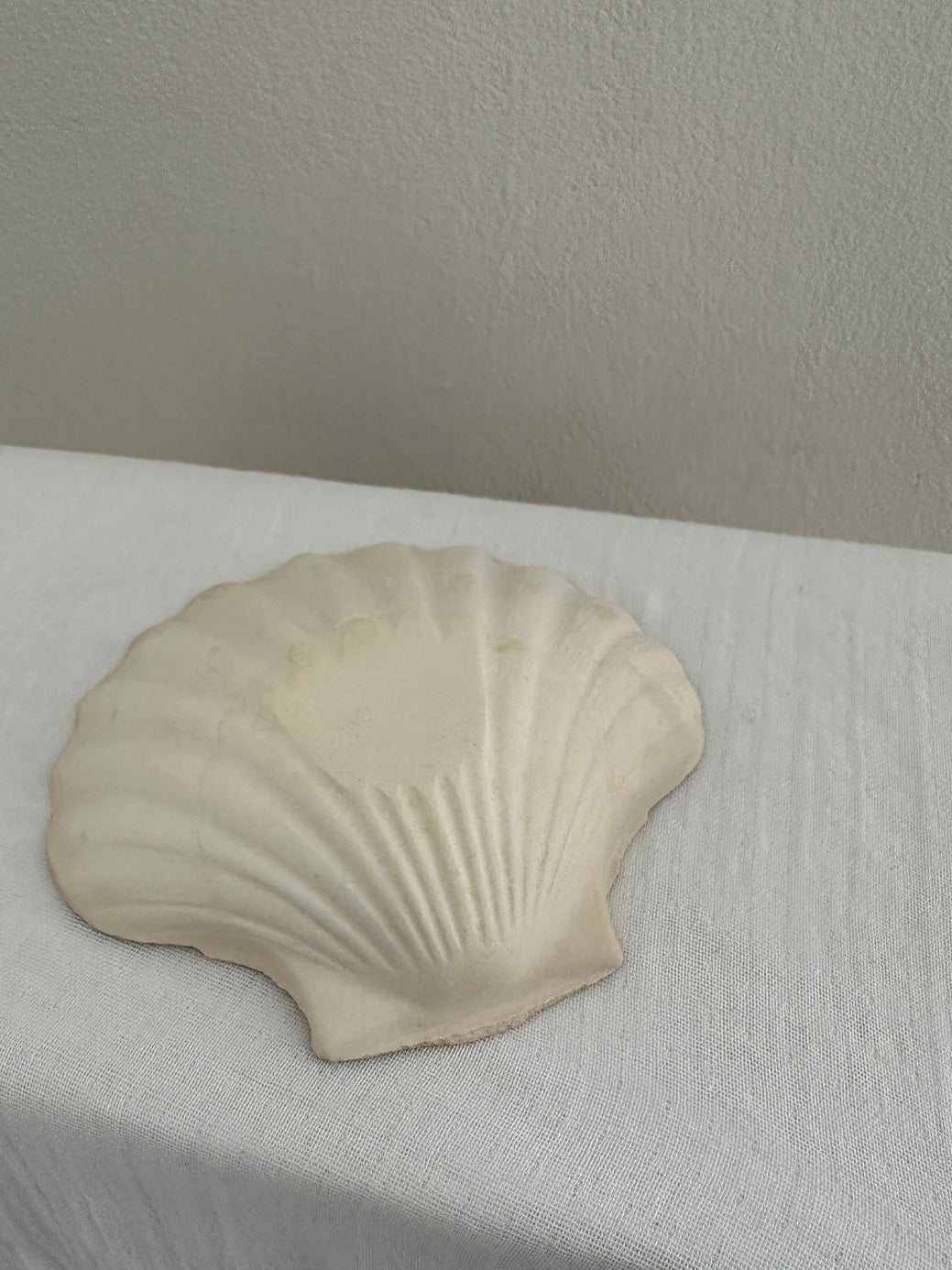 a set of four vintage french scallop serving dishes in natural, unglazed clay