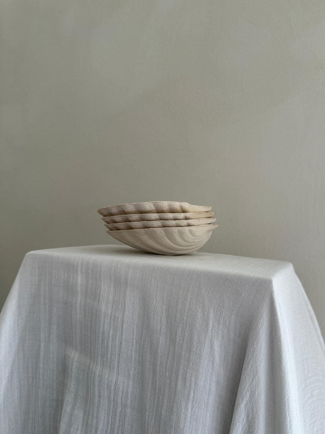 a set of four vintage french scallop serving dishes in natural, unglazed clay