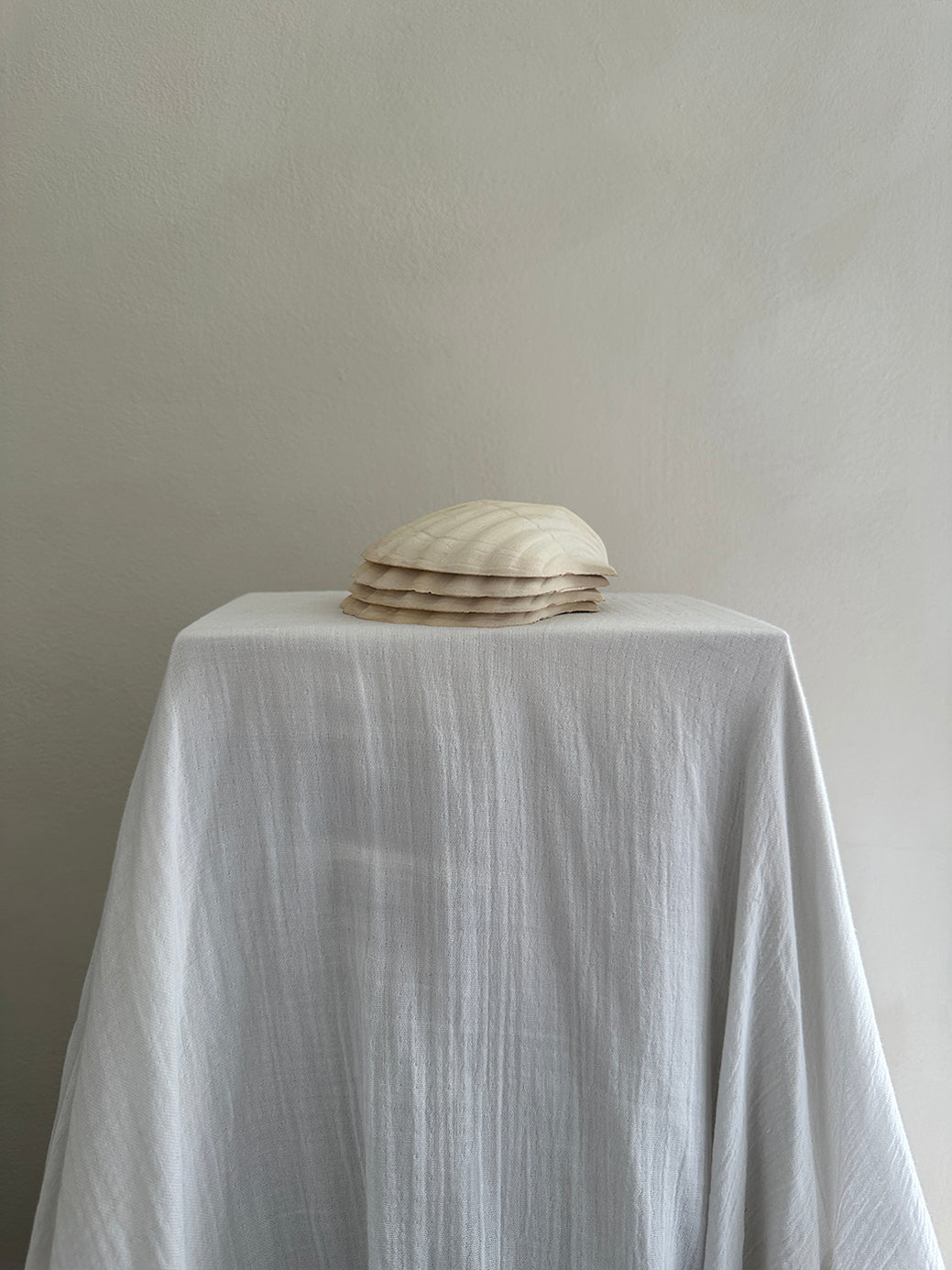 a set of four vintage french scallop serving dishes in natural, unglazed clay