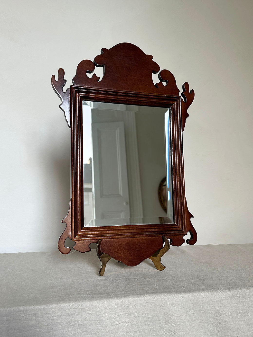 a pair of antique mahogany chippendale-style mirrors with bevelled glass