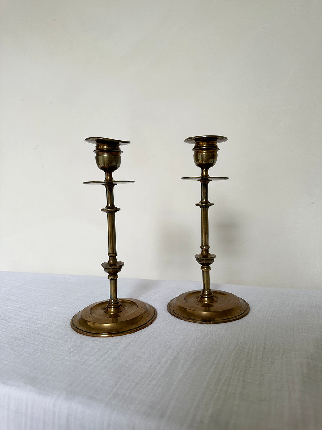 a beautiful pair of antique brass candlesticks 