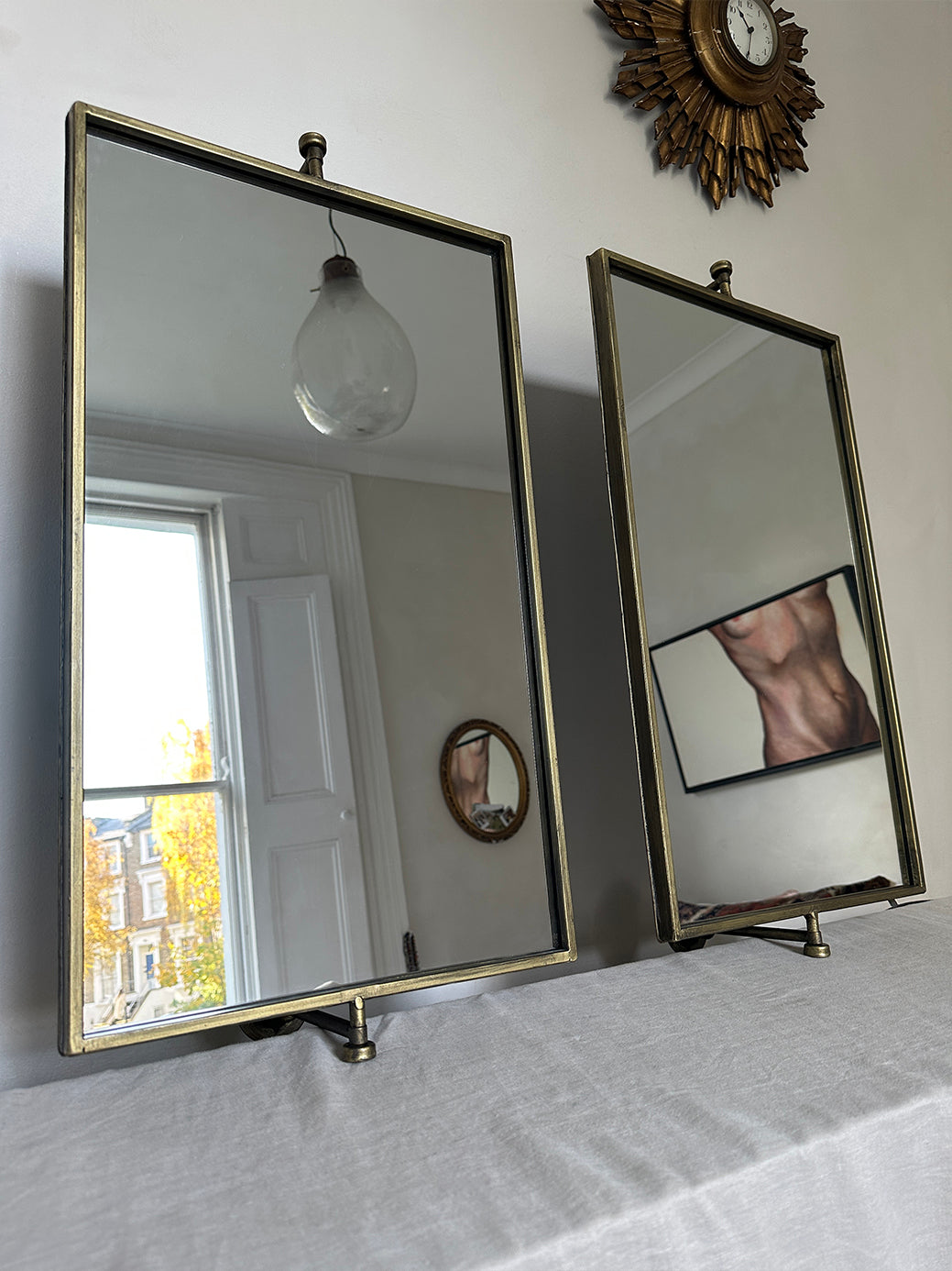 pair of vintage brass mirrors on swivel wall mounts