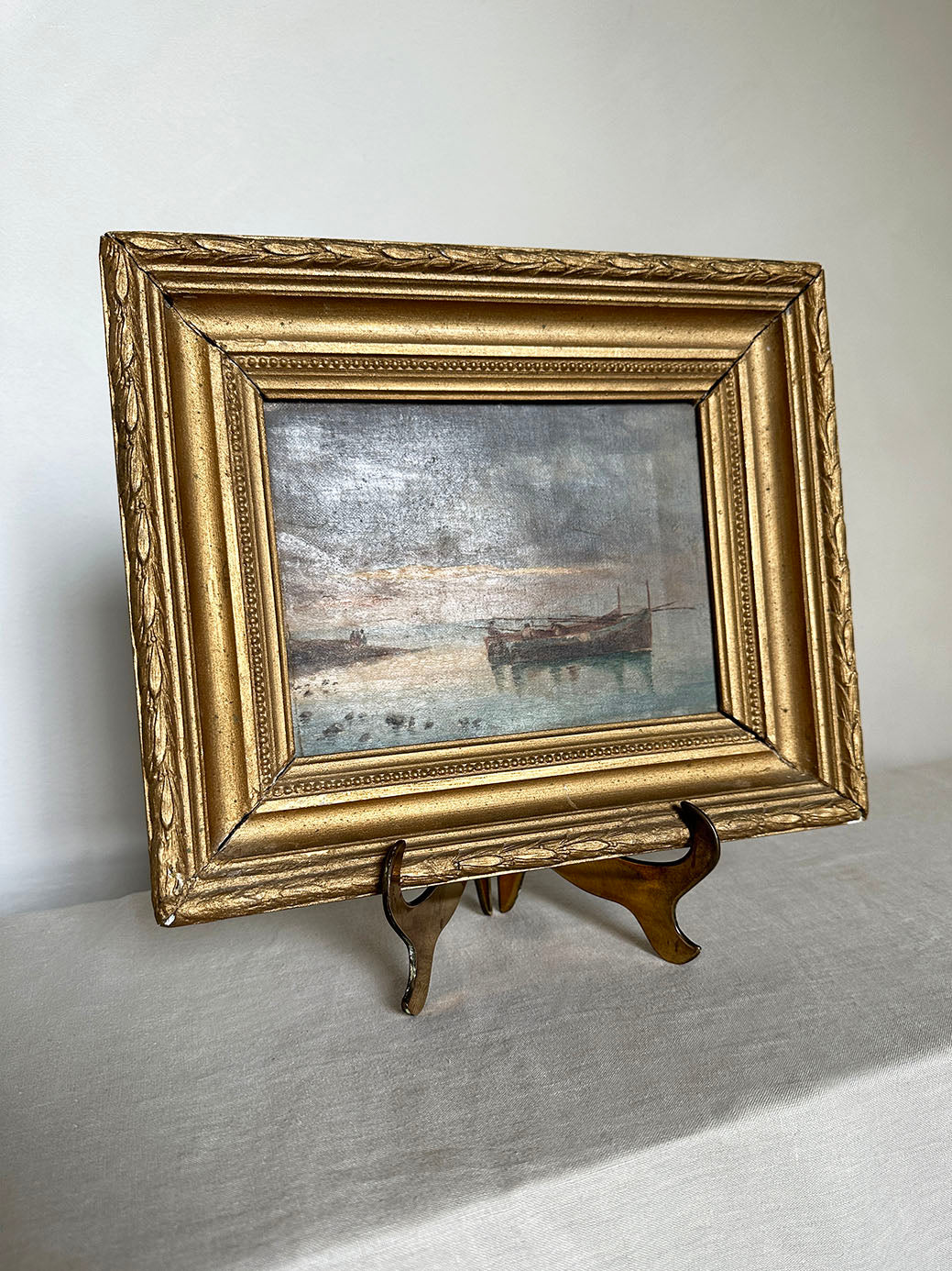 a small antique oil seascape with an ornate gilt frame