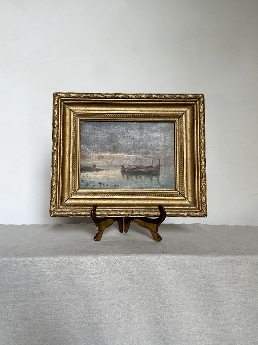 a small antique oil seascape with an ornate gilt frame