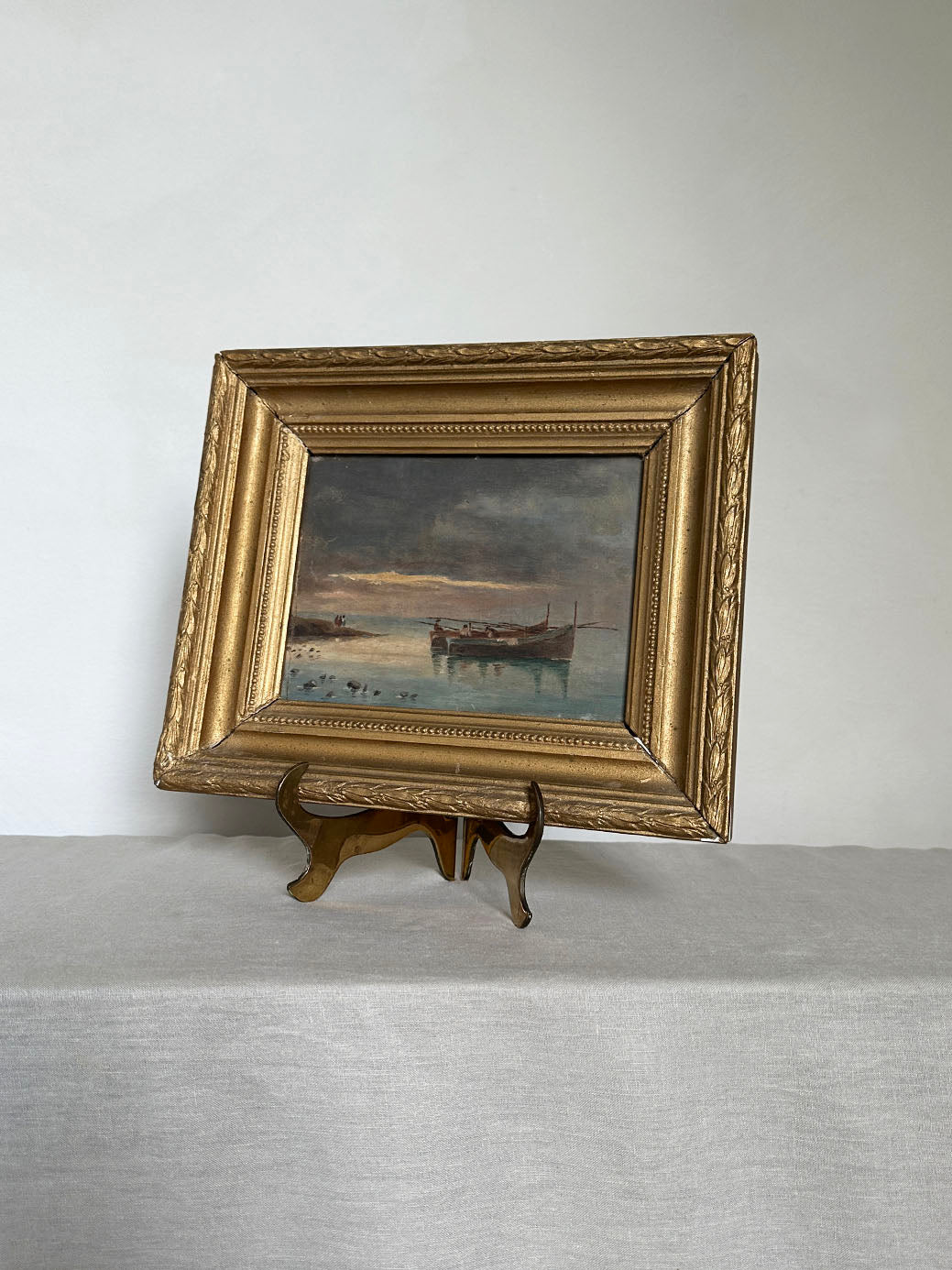 a small antique oil seascape with an ornate gilt frame