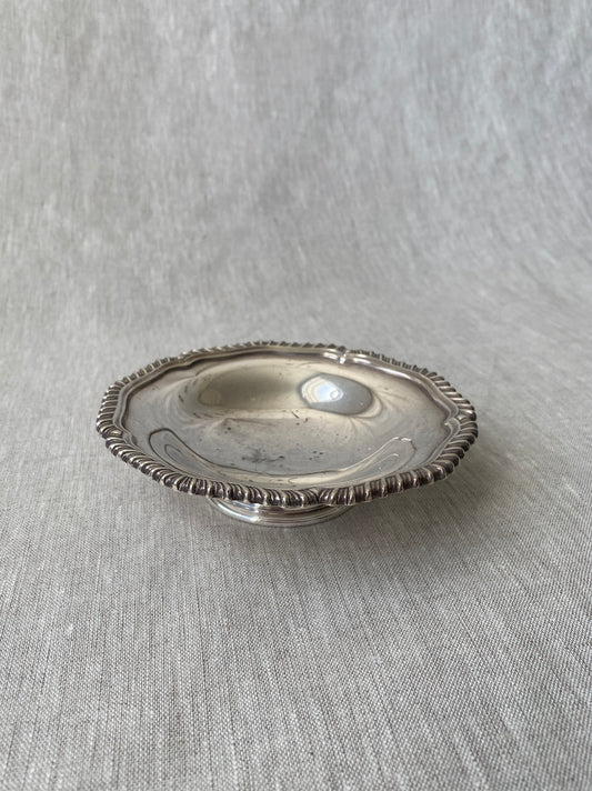 a small silver-plated trinket dish with elevated base