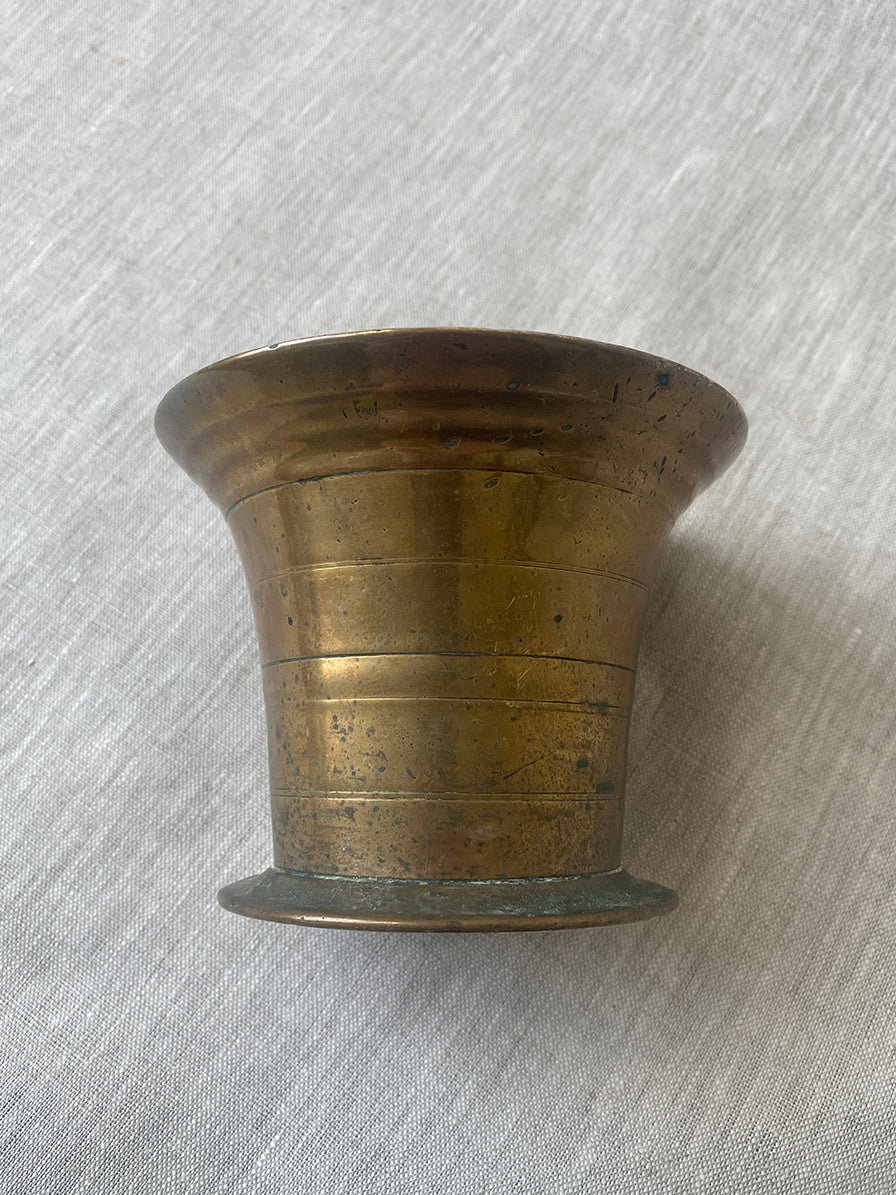 an antique medicial mortar and pestle in solid brass