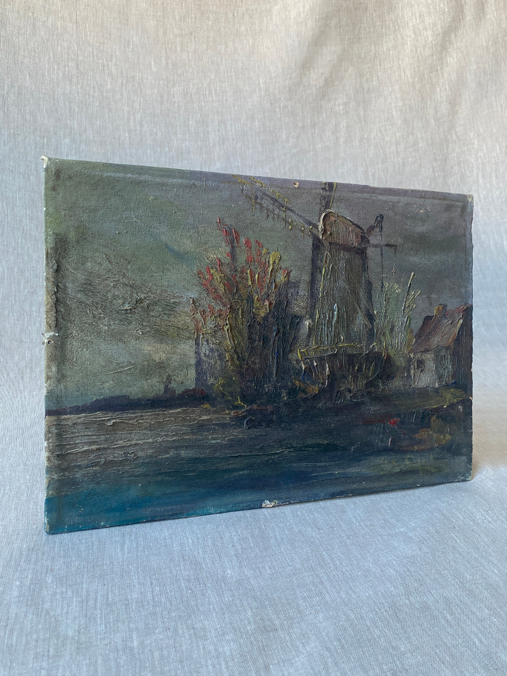 a vintage seascape painting with heavily applied oil paint on canvas frame