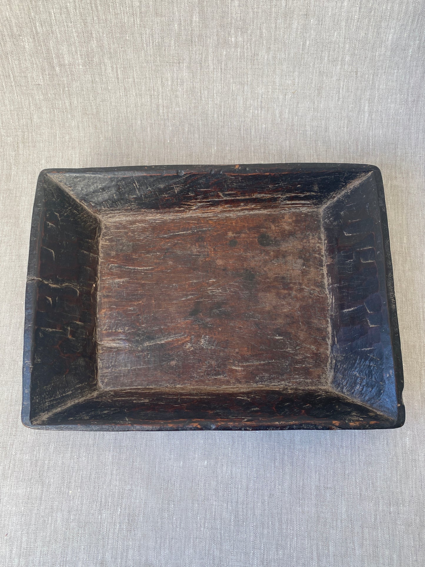 an antique hand carved wooden dish