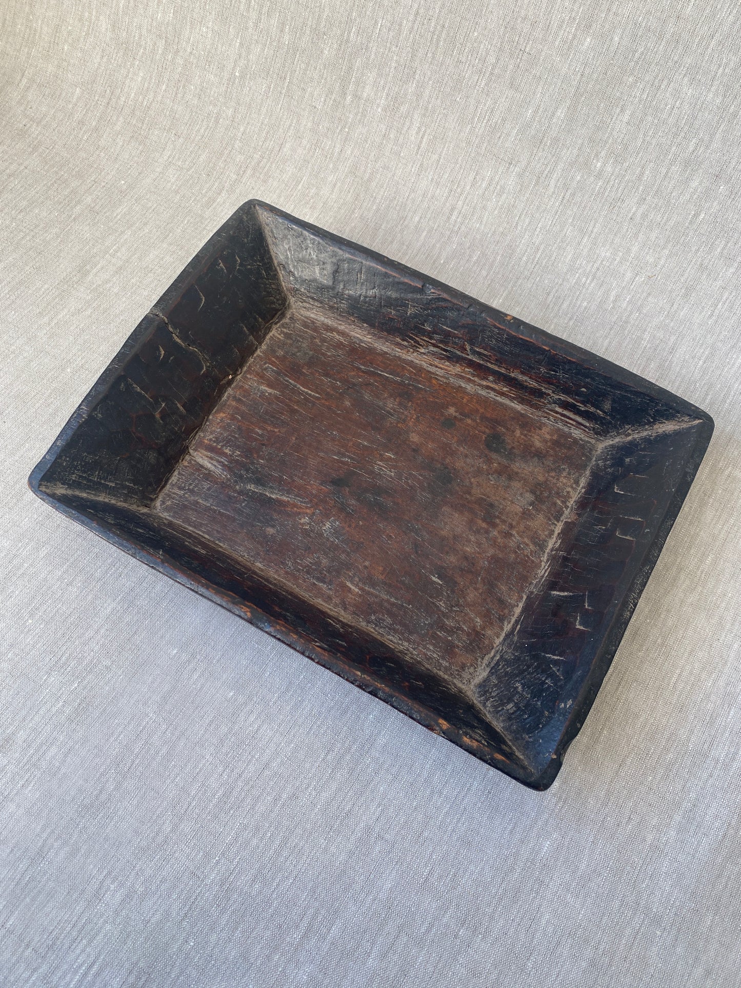 an antique hand carved wooden dish