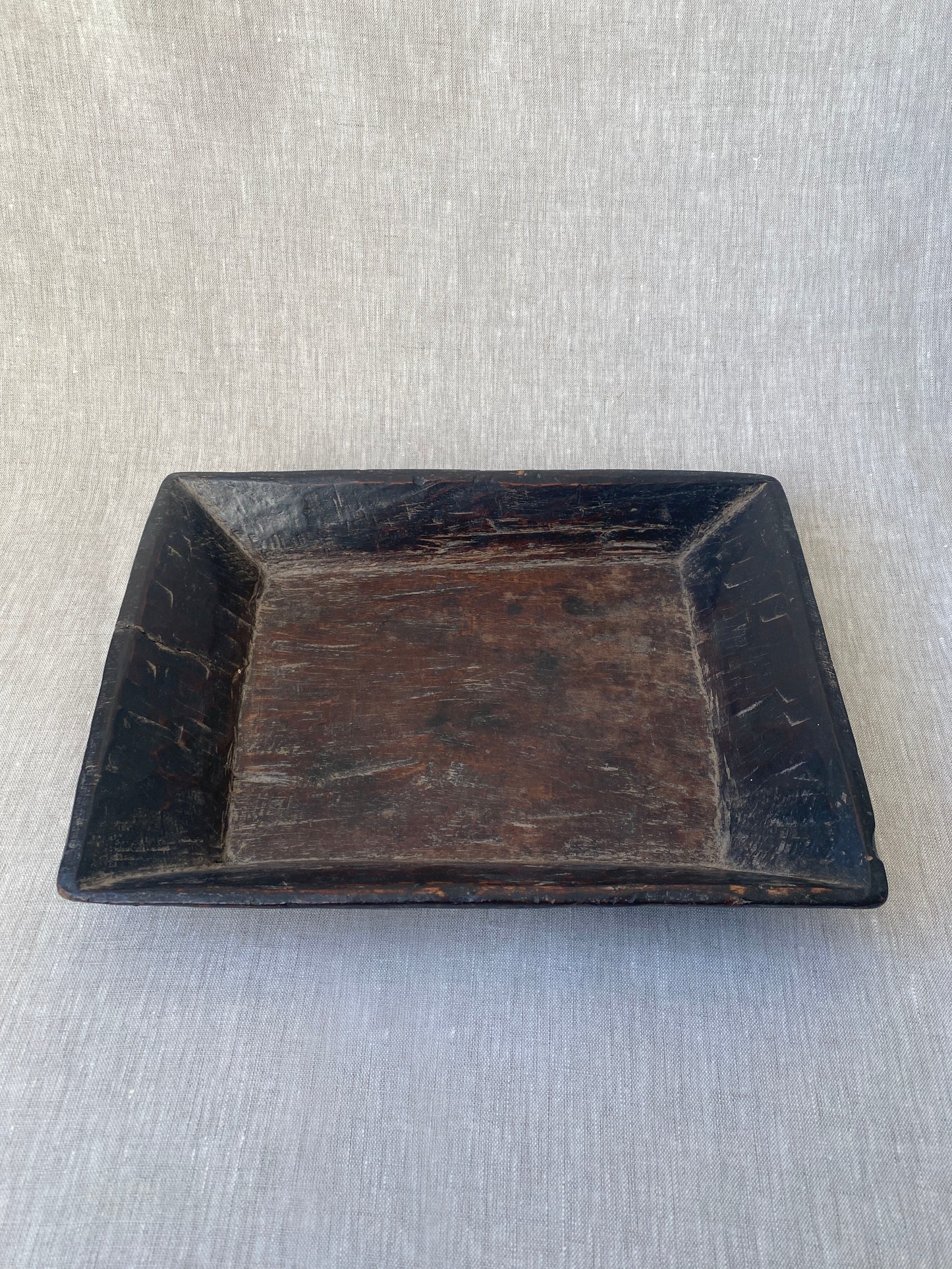 an antique hand carved wooden dish