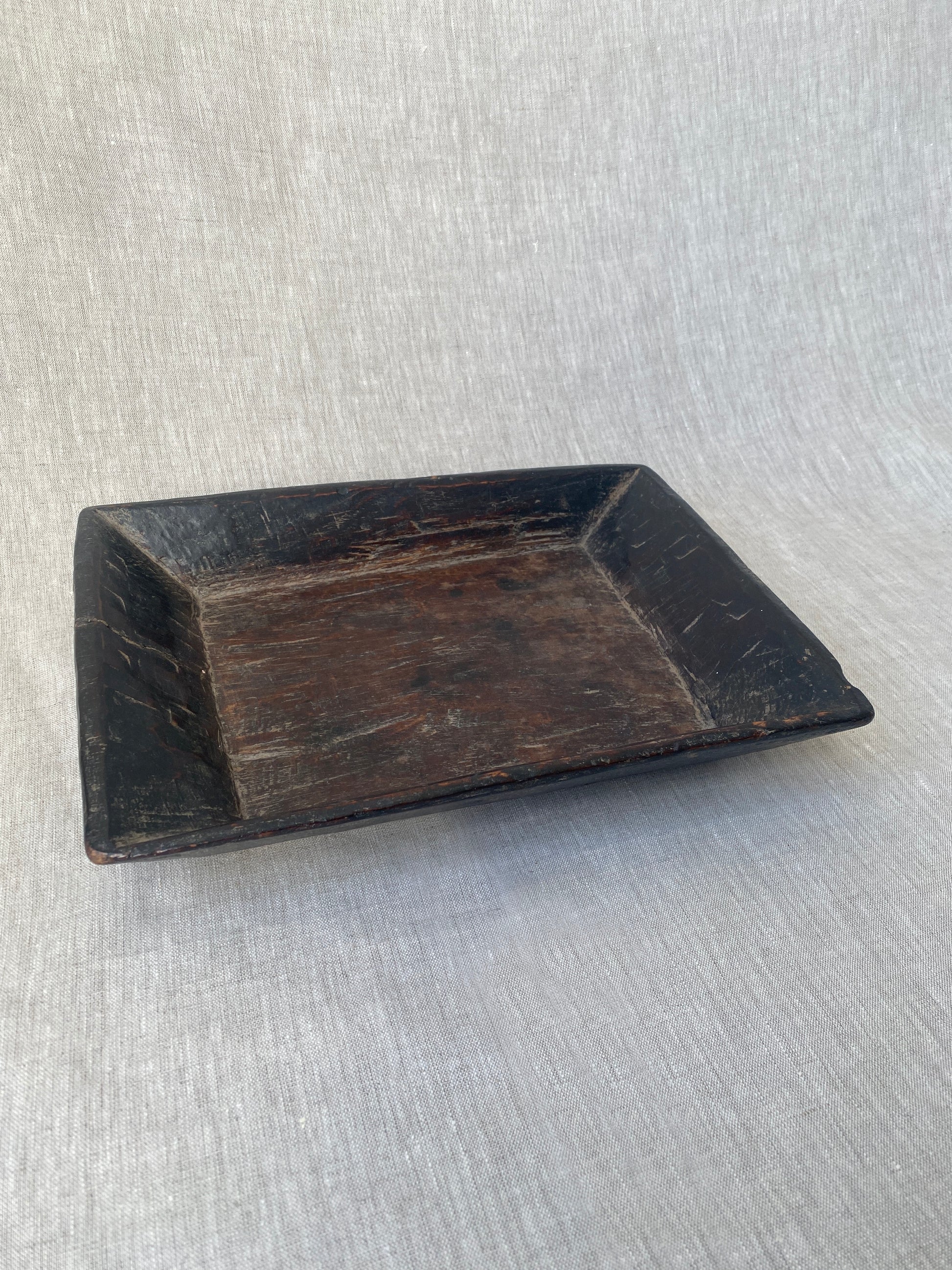 an antique hand carved wooden dish