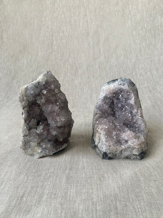 a pair of amethyst crystal geodes with beautiful lilac hues