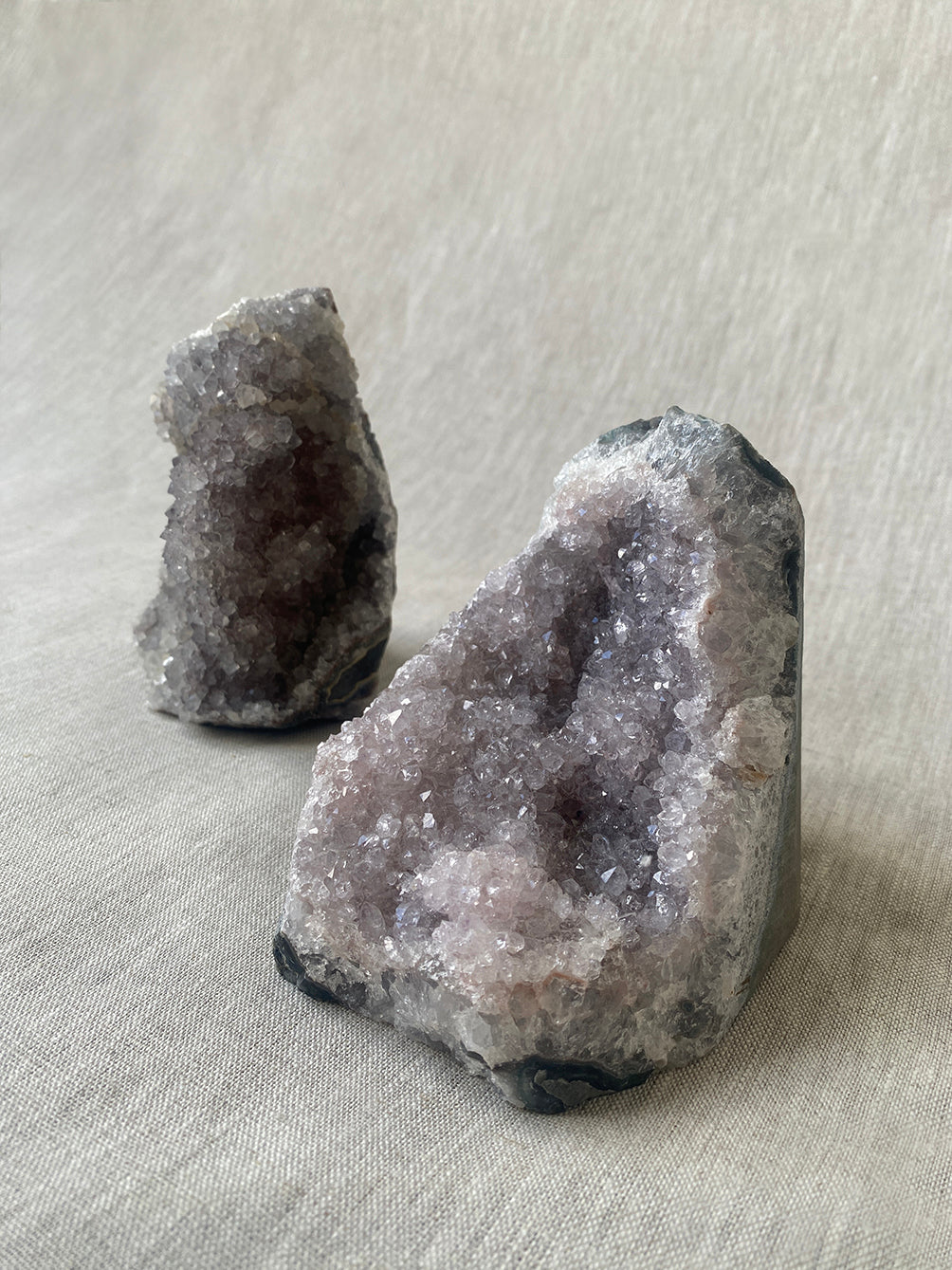 a pair of amethyst crystal geodes with beautiful lilac hues