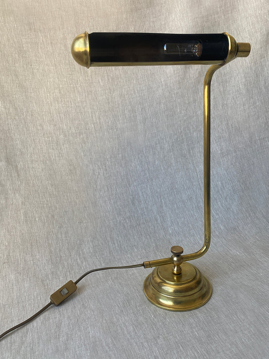 a mid-century solid brass table lamp with adjustable shade and stem