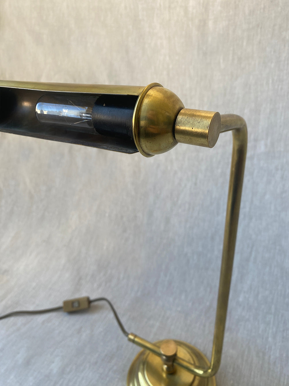 a mid-century solid brass table lamp with adjustable shade and stem