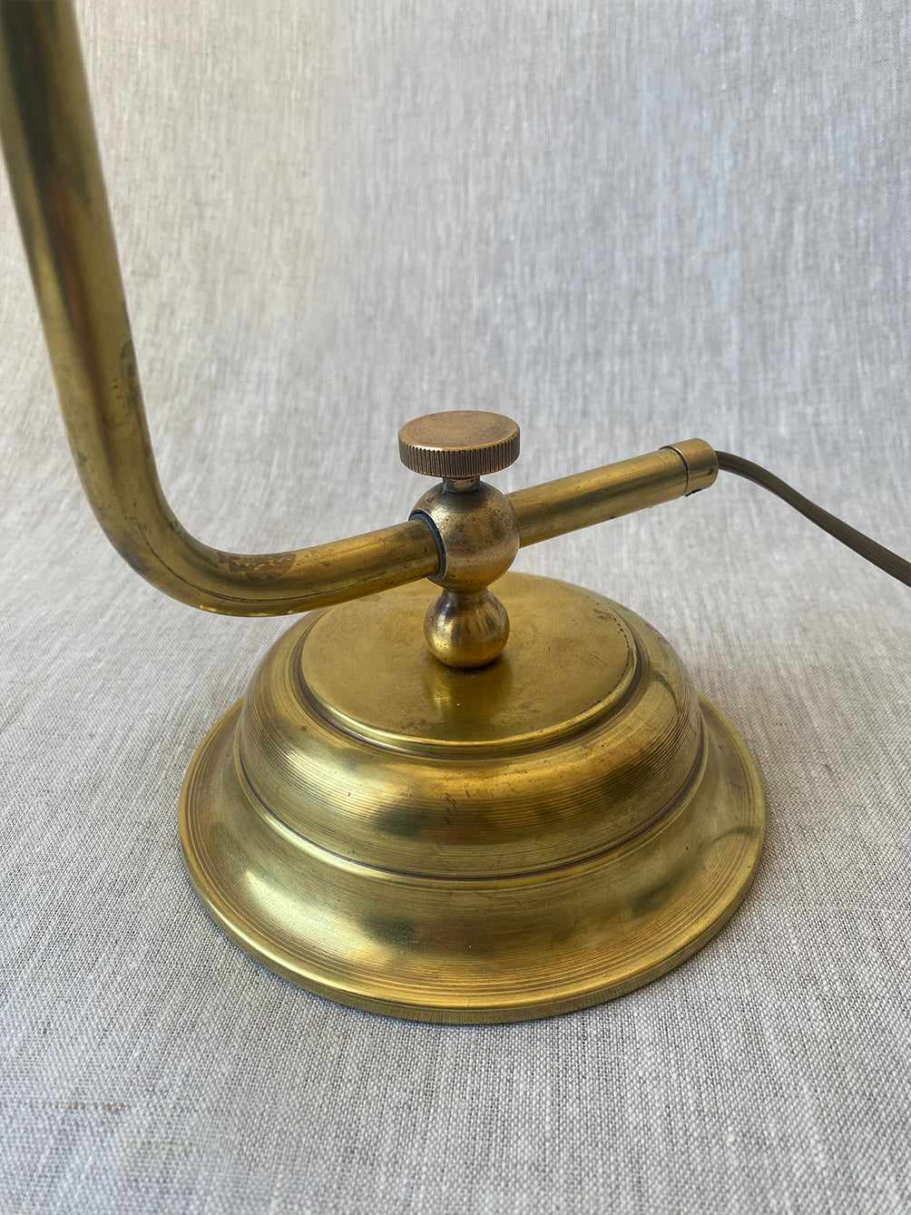 a mid-century solid brass table lamp with adjustable shade and stem