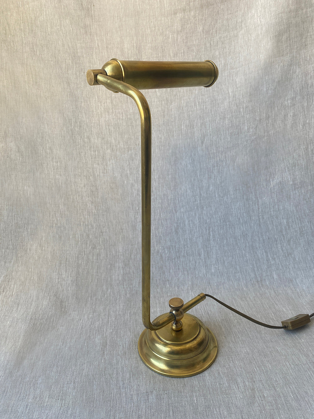 a mid-century solid brass table lamp with adjustable shade and stem